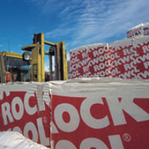 Production at stone wool factory - forklift storing products at outside stock